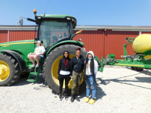 Group of youth in front of tractor